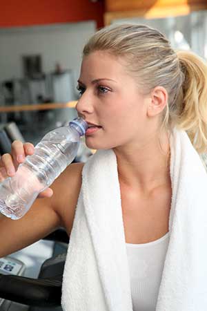 Woman Rehydrating at the Gym